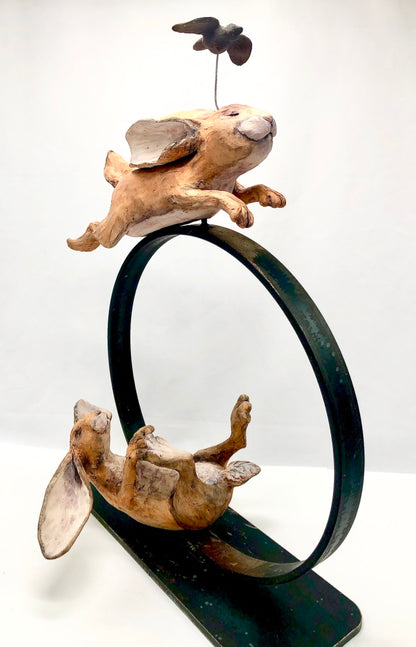 Ceramic Sculpture, Two Hares on Metal Ring: "Let Your Greatness Show From Your Inner Light"