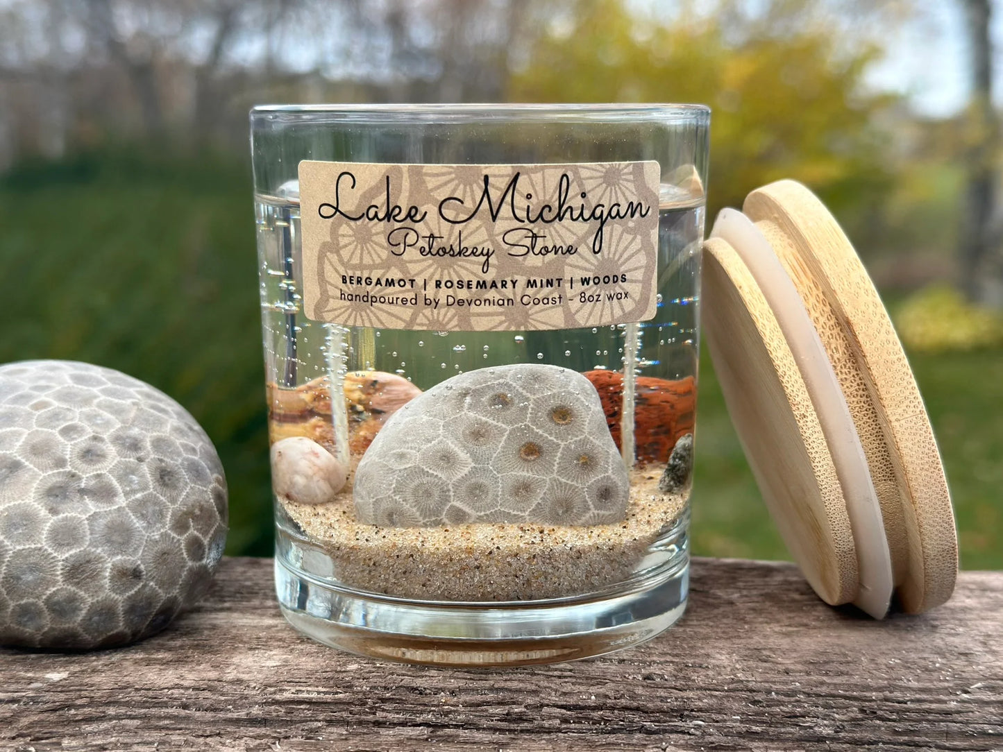 Gel candle, petoskey stone, leland blue, pudding stone, agate, sodalite, treasures remain after candle burns down, woodsy scent, 8 ounce, hanni gallery