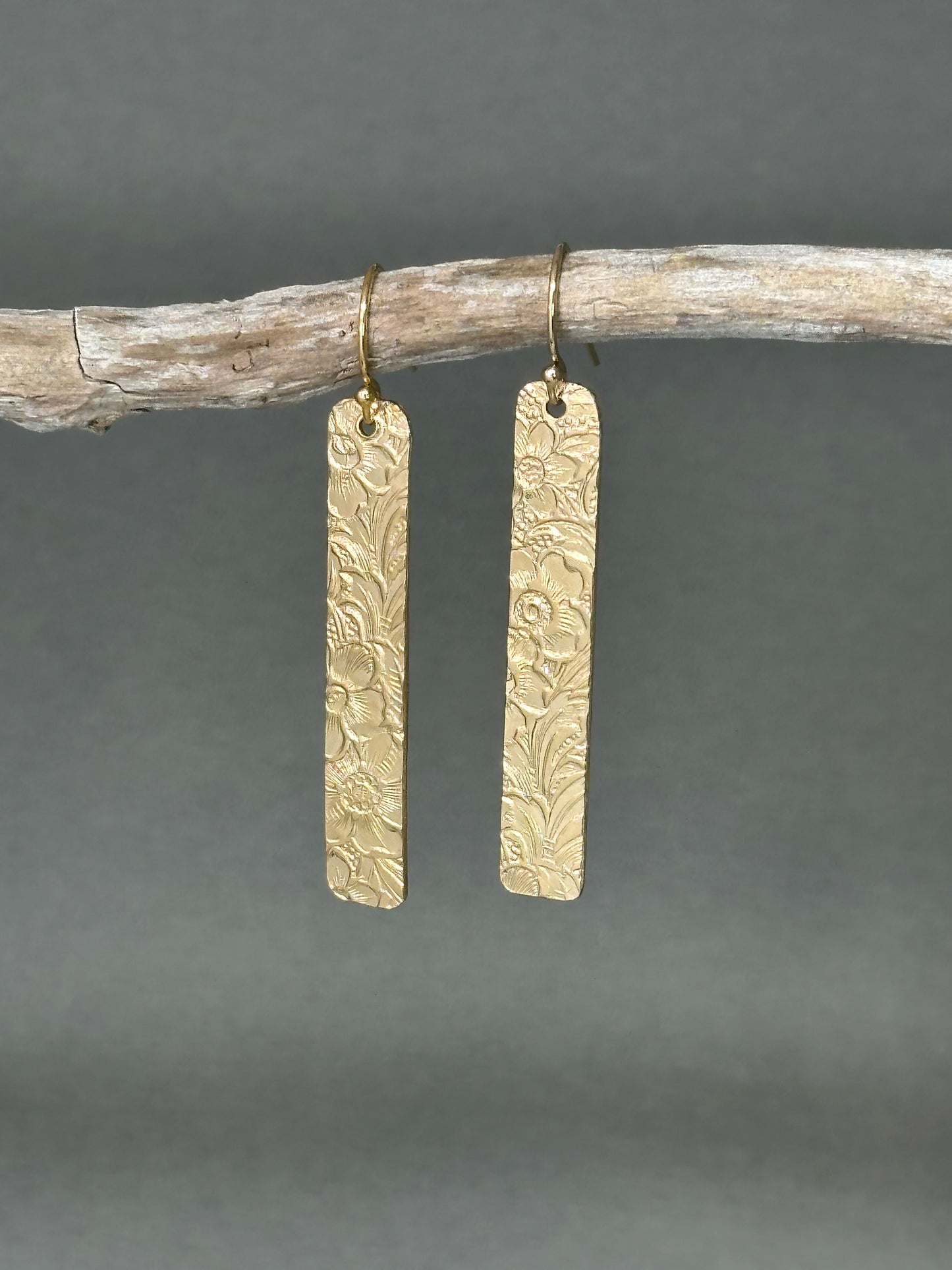 14kt gold filled or sterling bar dangle earrings with a 1/4" wide x 1.5" long bar with an embossed vintage floral pattern, hangs from standard ear wires or lever back hooks. hand crafted artisan jewelry by hanni jewelry, harbor springs, michigan.