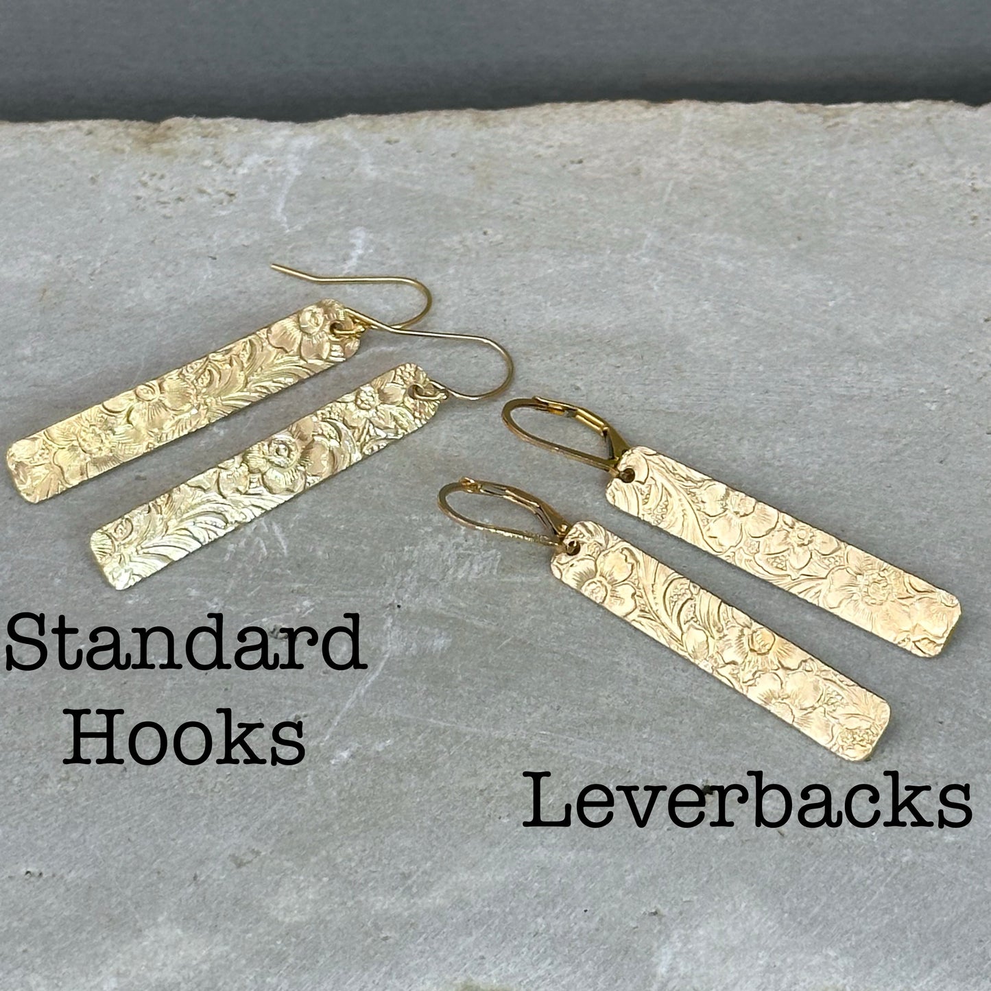 14kt gold filled or sterling bar dangle earrings with a 1/4" wide x 1.5" long bar with an embossed vintage floral pattern, hangs from standard ear wires or lever back hooks. hand crafted artisan jewelry by hanni jewelry, harbor springs, michigan.