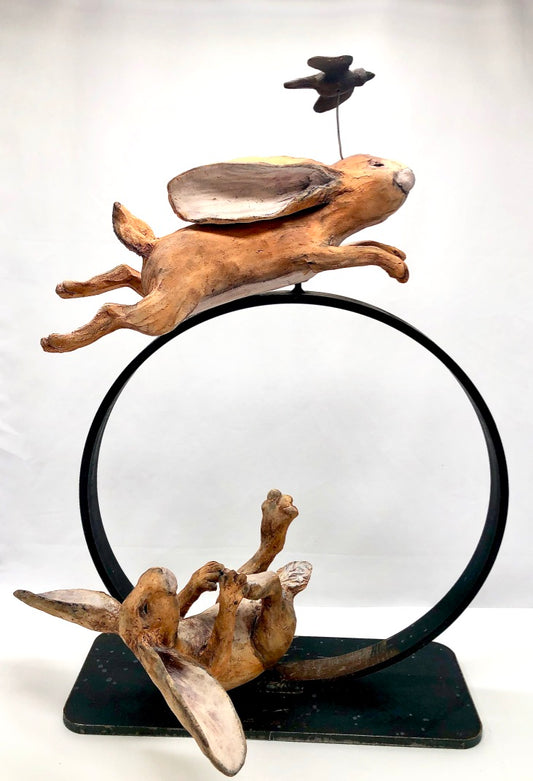 Hares on metal ring, leping hare and laughing hare, whimsical ceramic sculpture, hanni gallery