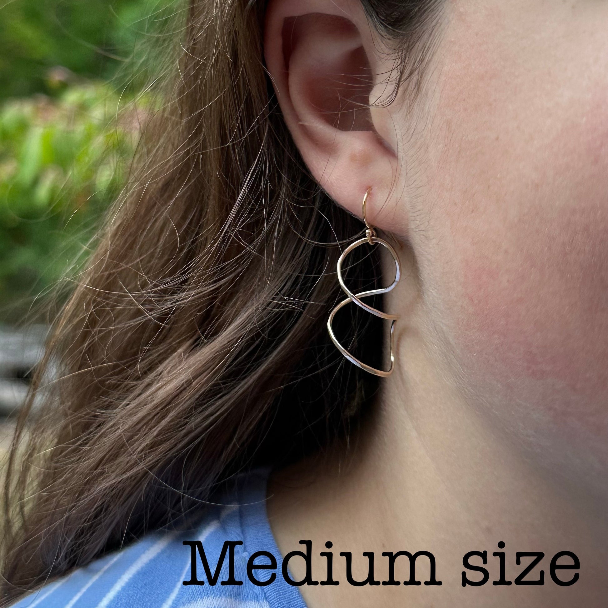 Twisty spiral wire earring on model  in sterling silver or 14kt gold filled, Simple modern dangle in four sizes 1 to 2 inches long, available on french hook or leverback ear wires, artist handmade by hanni jewelry in harbor springs, michigan