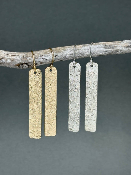 14kt gold filled or sterling bar dangle earrings with a 1/4&quot; wide x 1.5&quot; long bar with an embossed vintage floral pattern, hangs from standard ear wires or lever back hooks. hand crafted artisan jewelry by hanni jewelry, harbor springs, michigan.