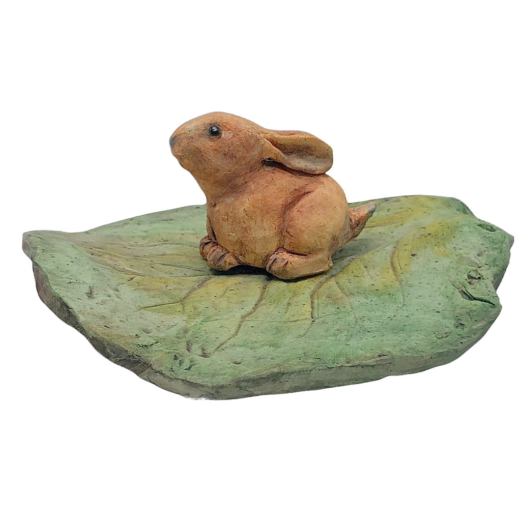 Small ceramic rabbit crouched on leaf, 2 separate pieces, realistic expression, local artist, hanni gallery, harbor springs