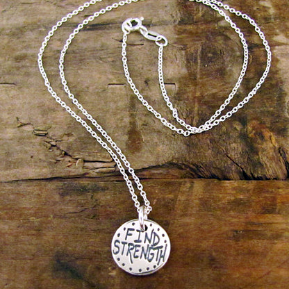 sterling silver disc charm with words let go on one side and find strength on the other artist made jewelry