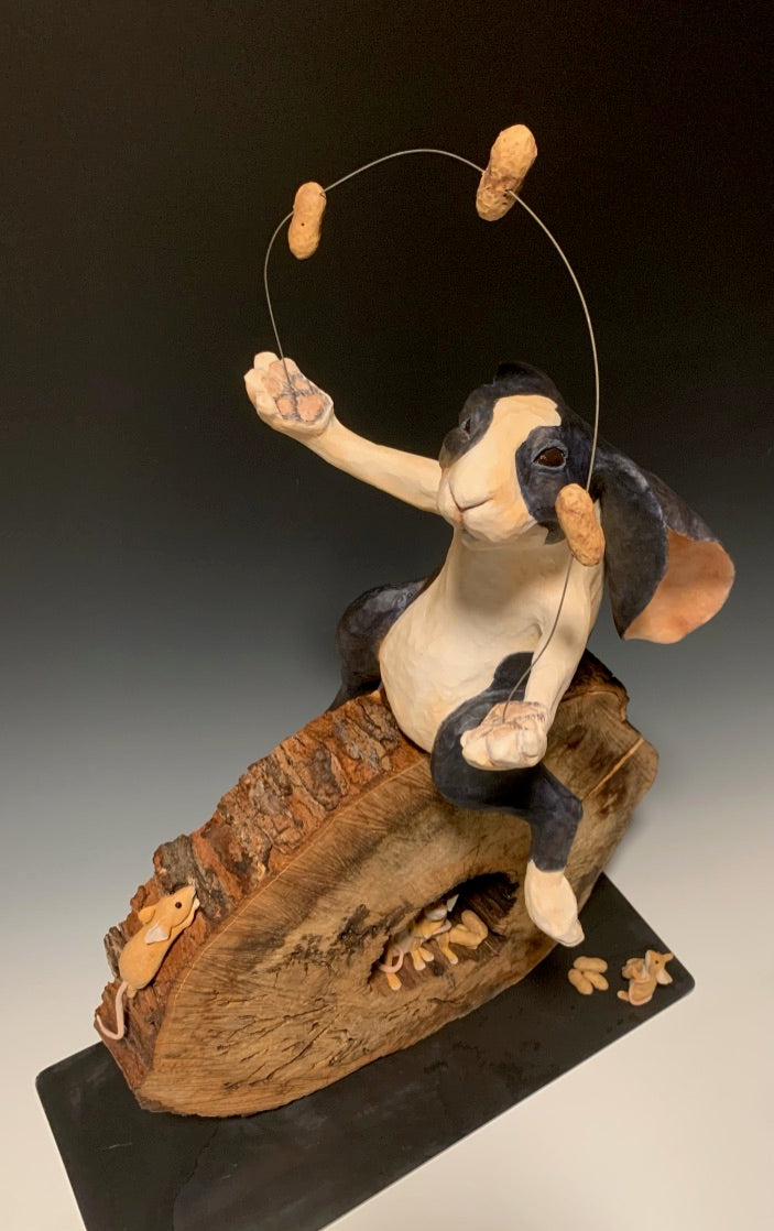 Ceramic sculpture, large black and white rabbit sitting on log round juggling peanuts, mice watching and taking peanuts, northern michigan artist, hanni gallery, harbor springs 
