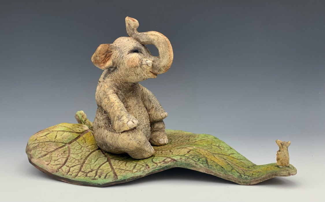 Ceramic elephant and mouse on leaf, meeting for the first time, happy elephant, northern michigan artist, hanni gallery, harbor spaings